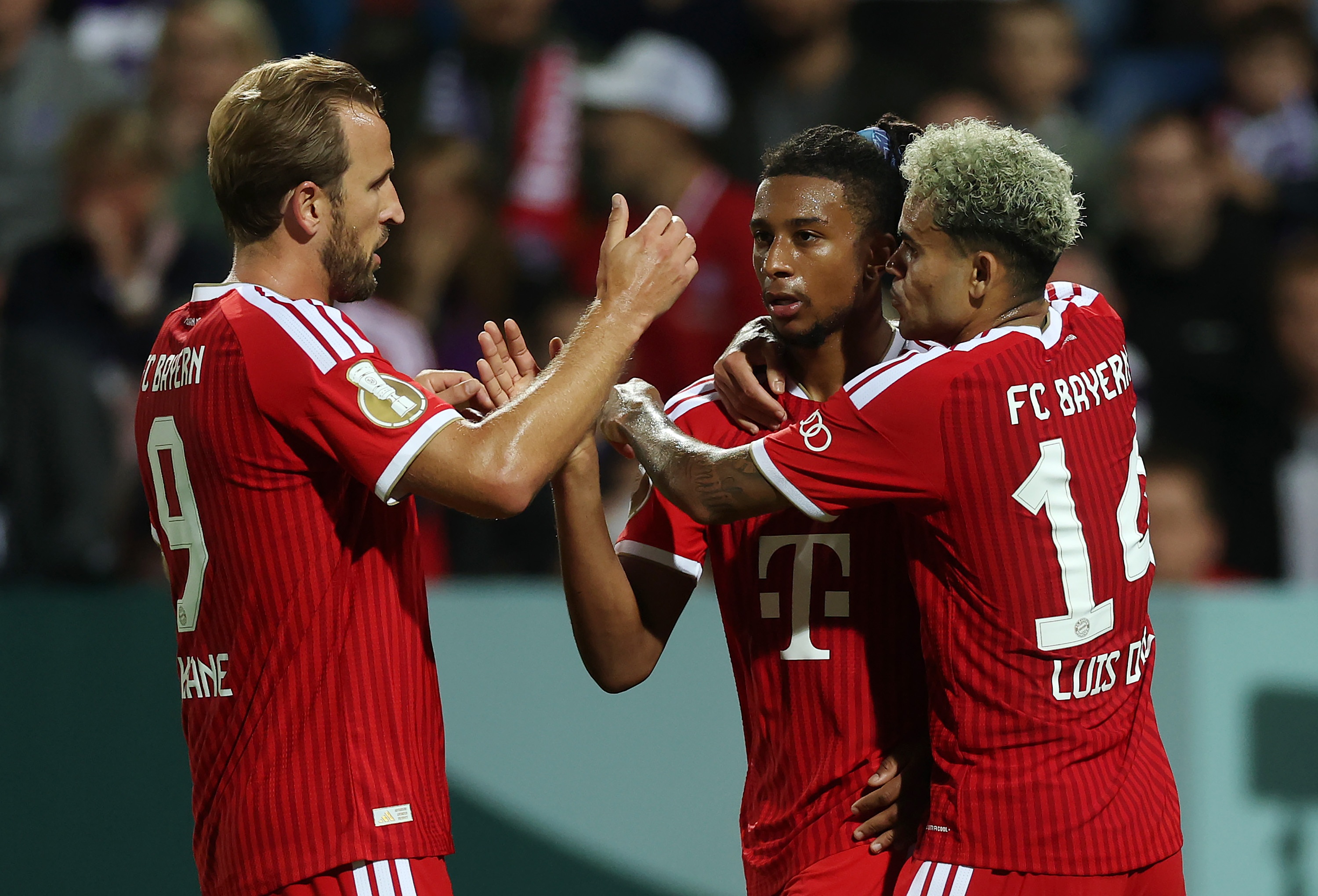 Michael Olise celebrates with Bayern Munich players Harry Kane and Luis Diaz.