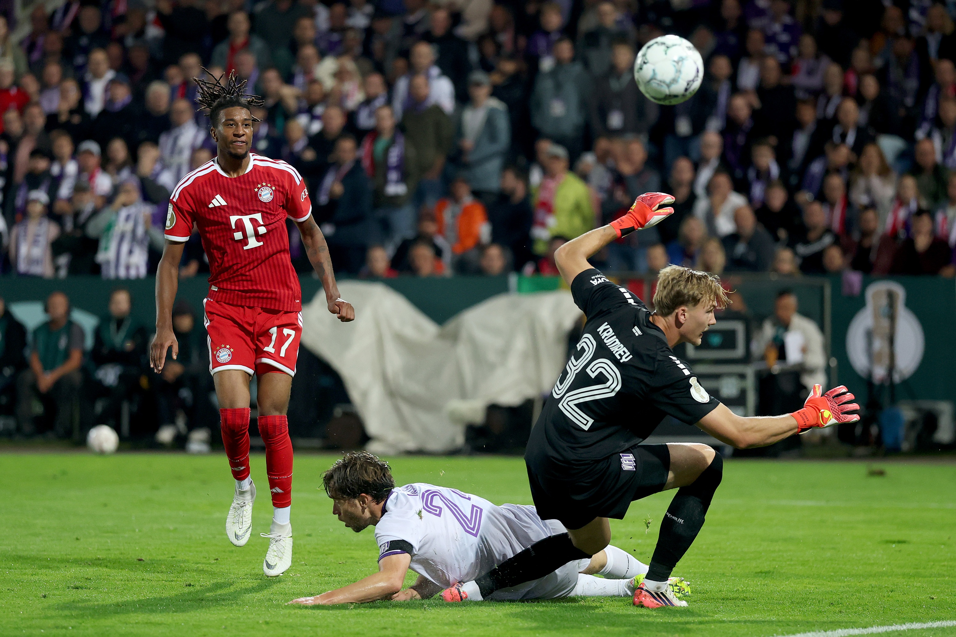 Michael Olise watches the ball fly over Osnabrück goalkeeper.