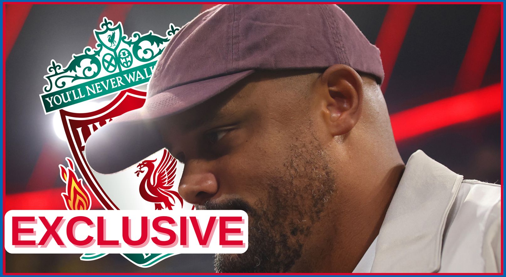 Vincent Kompany looks on in front of Liverpool club crest.